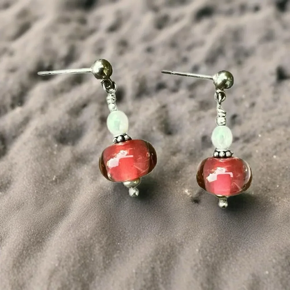 Earrings made with handcrafted blown glass in silver and pink-peach color